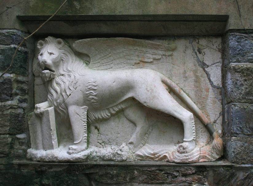 High relief carving of St Mark as a winged lion. Marble.